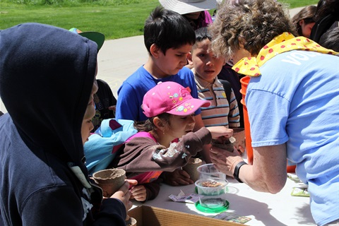 A group of children create their own seedlings during Heritage Days.
