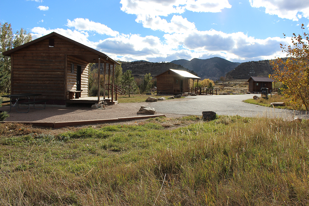 Three cabins are pictured within the Bear Creek Lake Park campground.