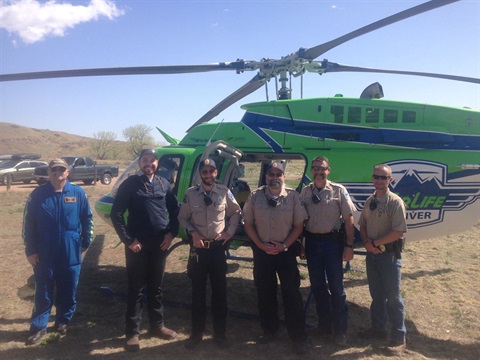 park rangers standing in front of a helicopter.jpg