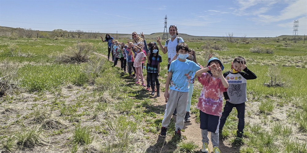 A school group poses on a trail.