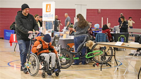 a man pushing his son in a wheelchair