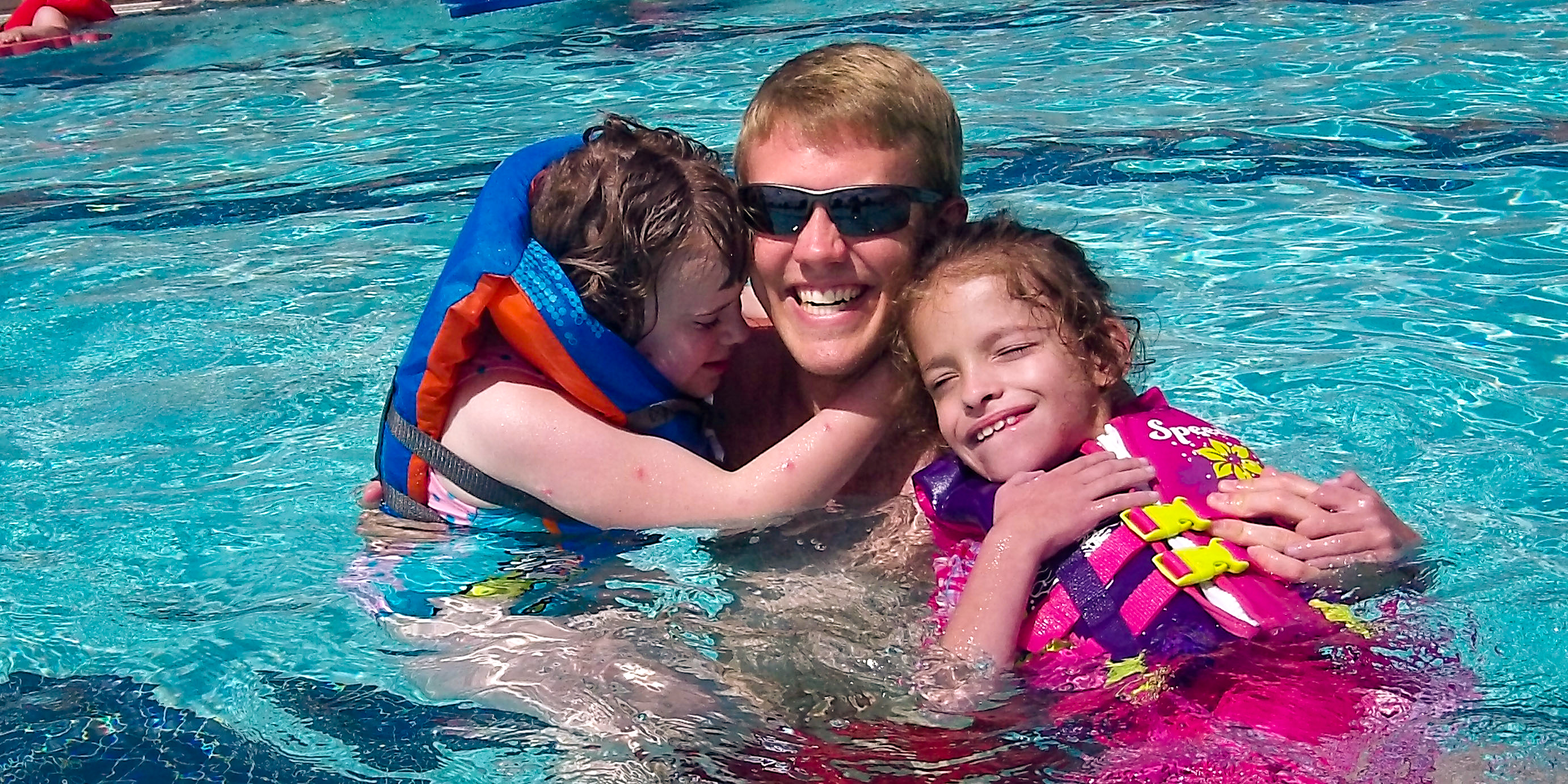 A staff member helps Paha participants in the pool.