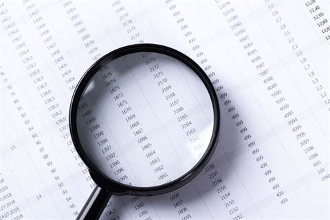 magnifying glass on top of paper