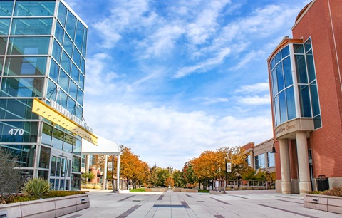 A building on the left and right side with a sidewalk in between