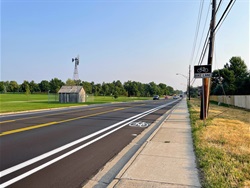 A street with a sidewalk next to it. 