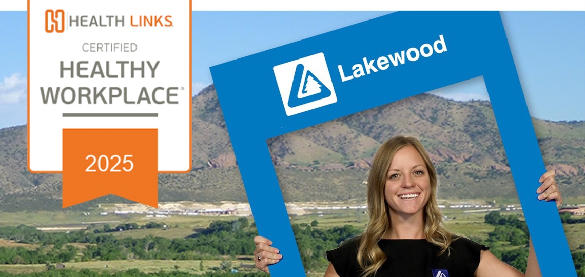 Lakewood employee holding a Lakewood sign