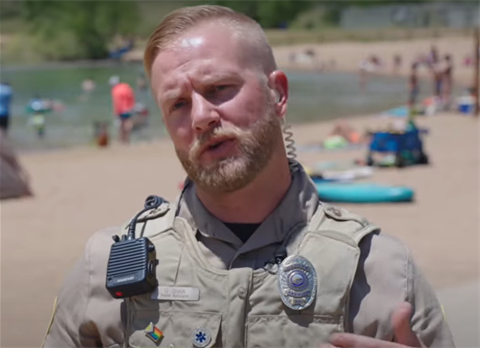 Park Ranger standing on the beach at Bear Creek Lake Park