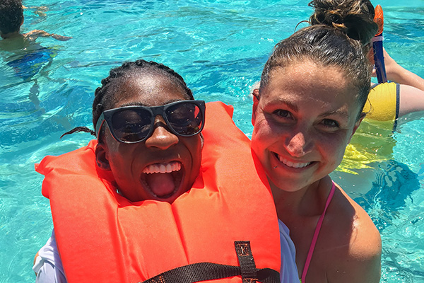 A staff member and participant in a pool.