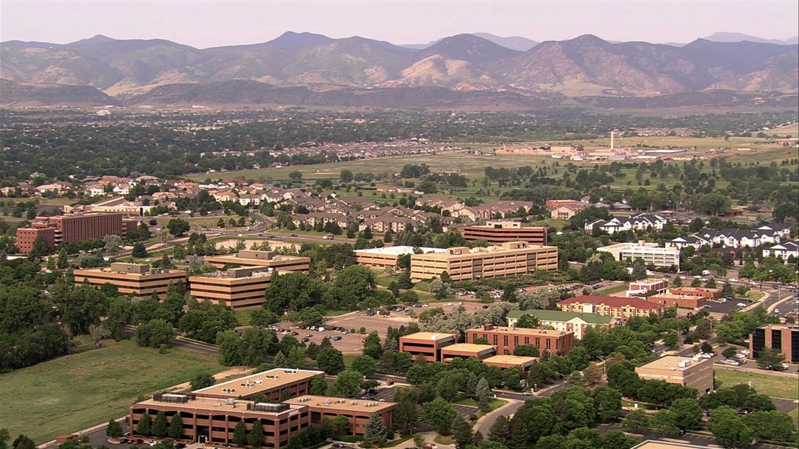 An aerial of a Lakewood with mountains in the background. 
