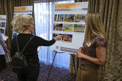 Planner discussing union corridor design board with a Lakewood resident. 