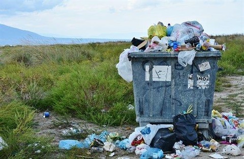 Overflowing trash in a field.